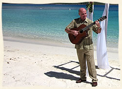 St. Thomas guitarist playing at wedding on tropical beach.